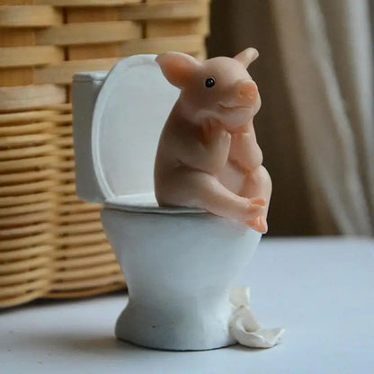 Figurine de cochon assise sur les toilettes